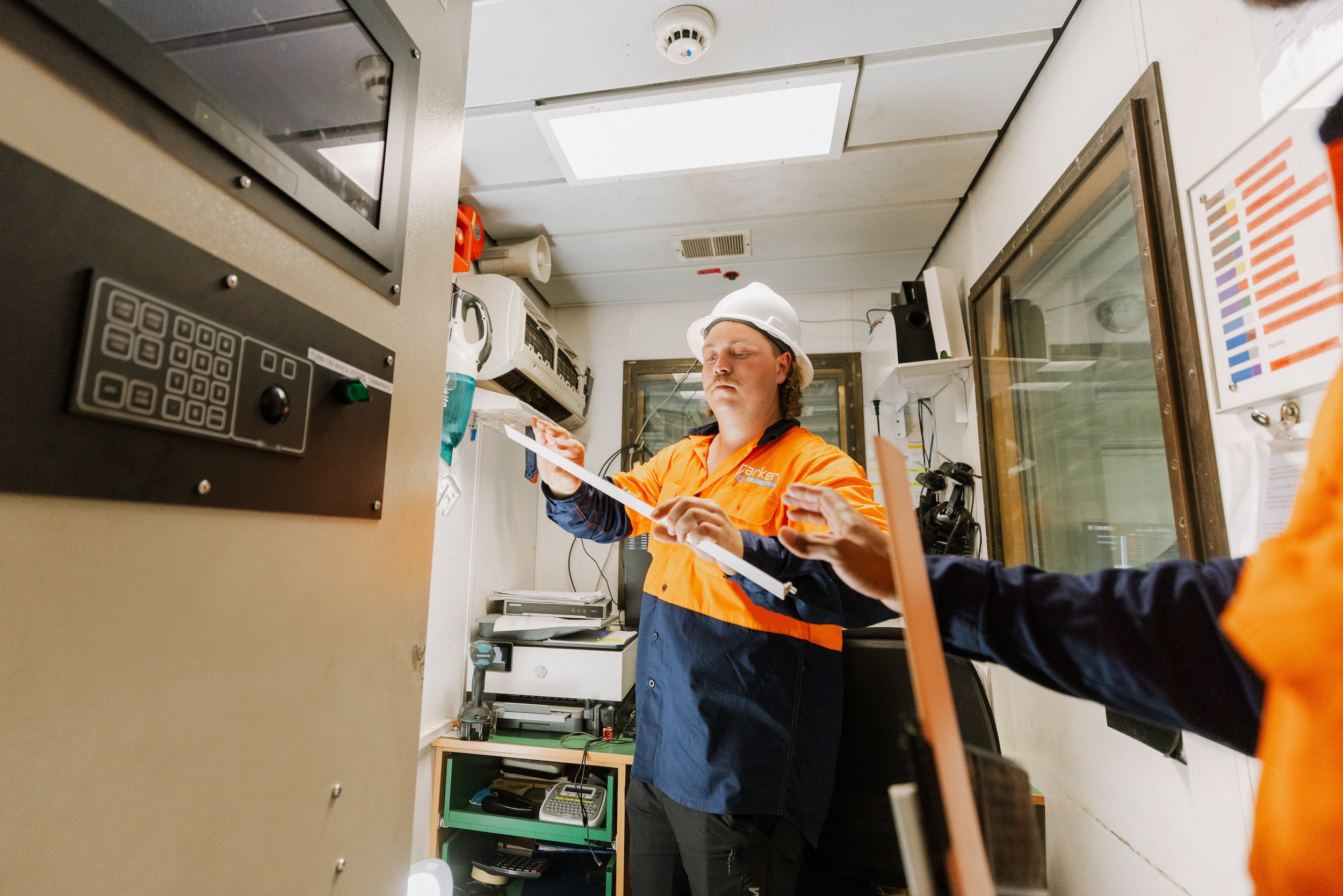 Technician working on marine AC in boat office