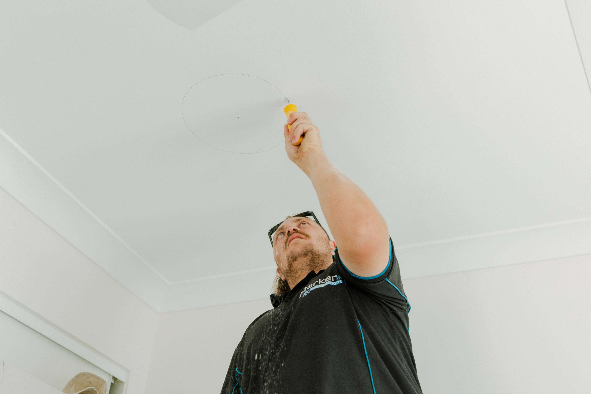 Cutting a ceiling opening for a ducted air conditioning vent in Kallangur home