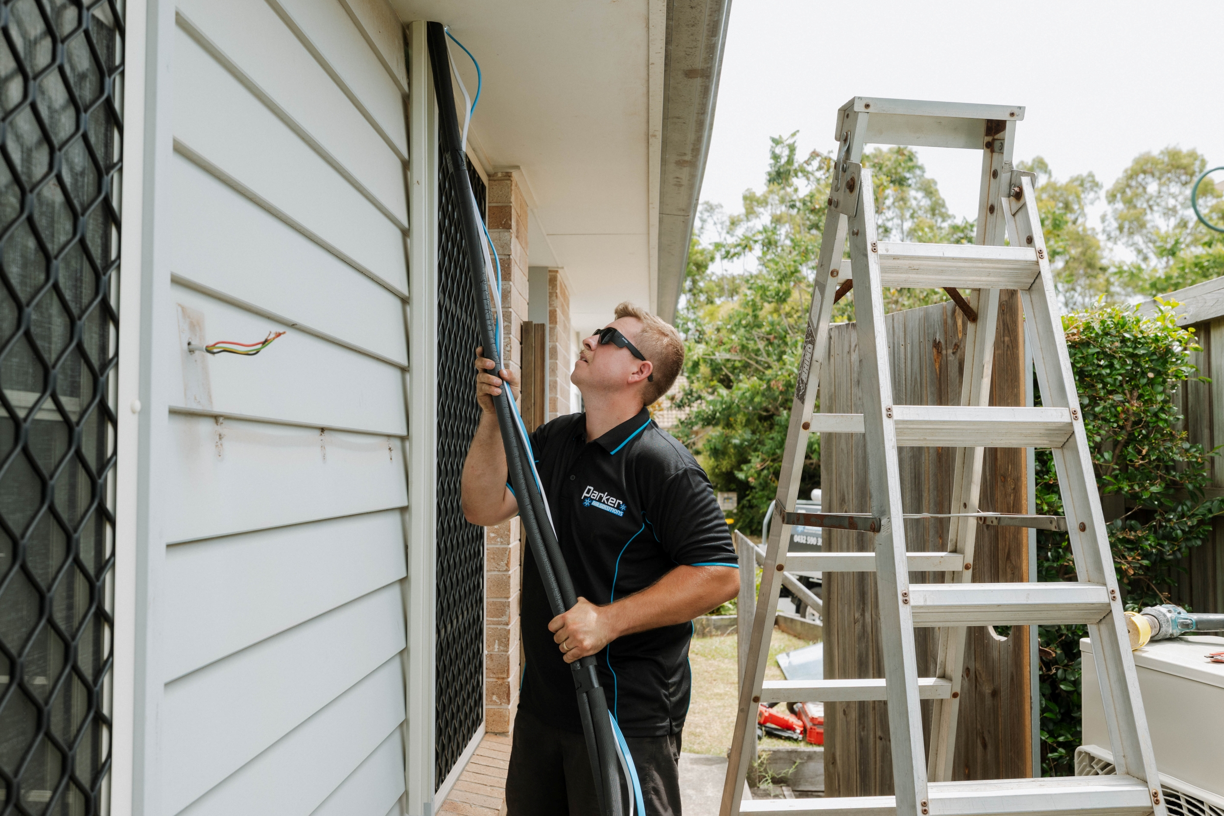 Installing refrigerant copper pipework on exterior wall for ducted aircon