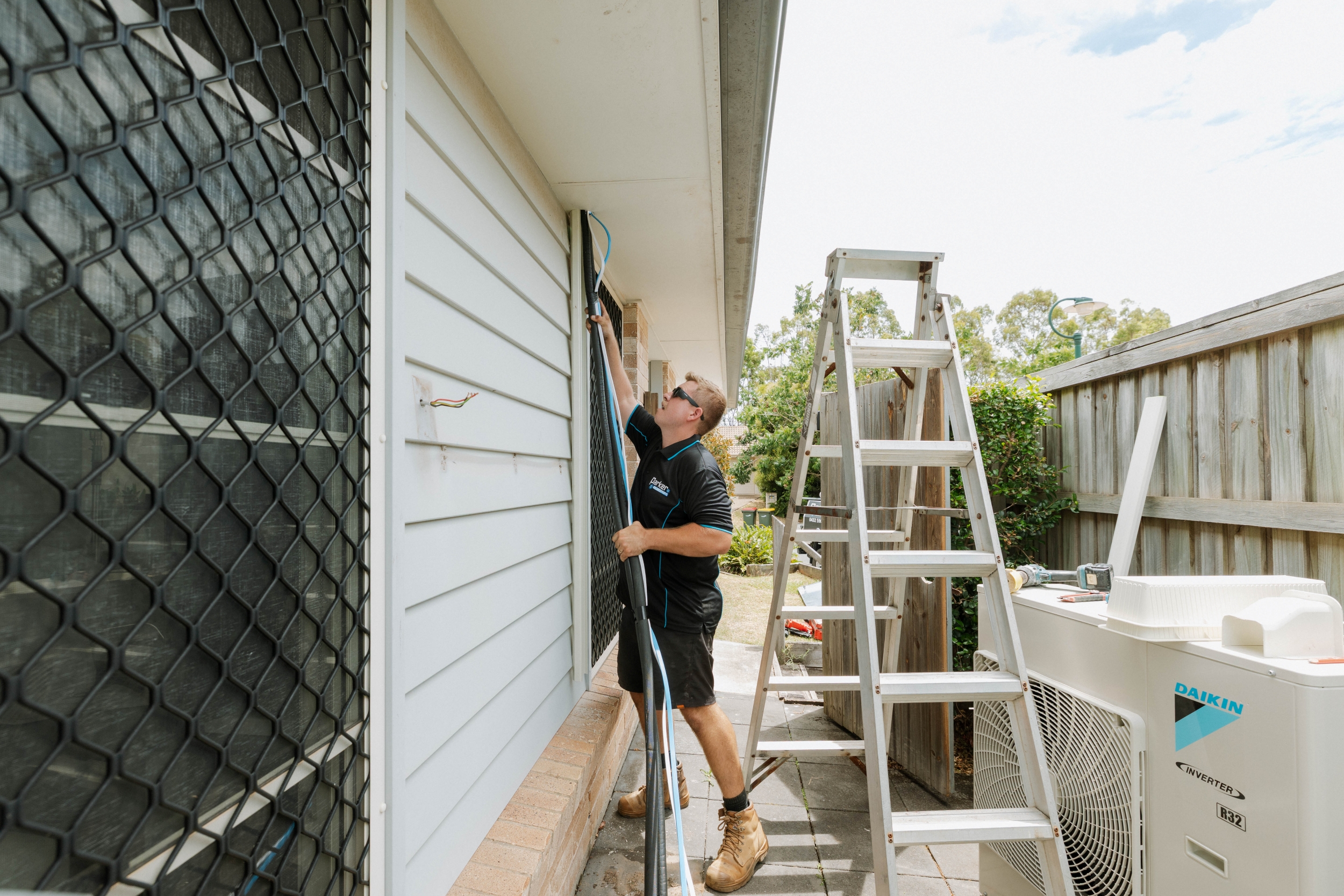 Running refrigerant lines along exterior wall to Daikin outdoor unit