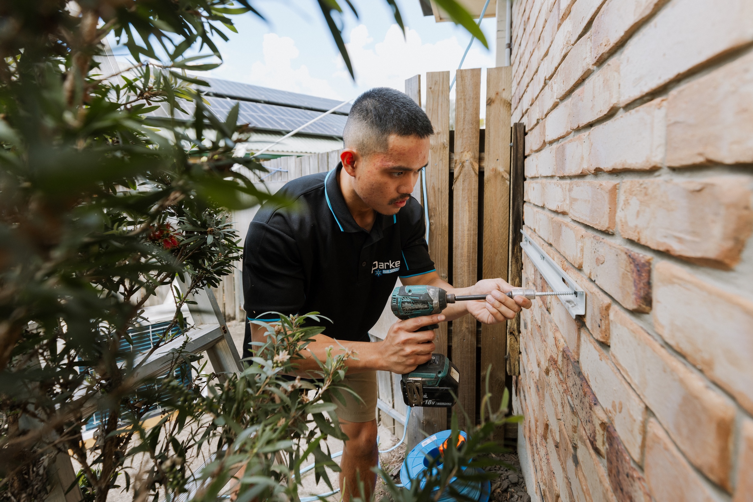 Electrician professionally connecting wires during AC installation