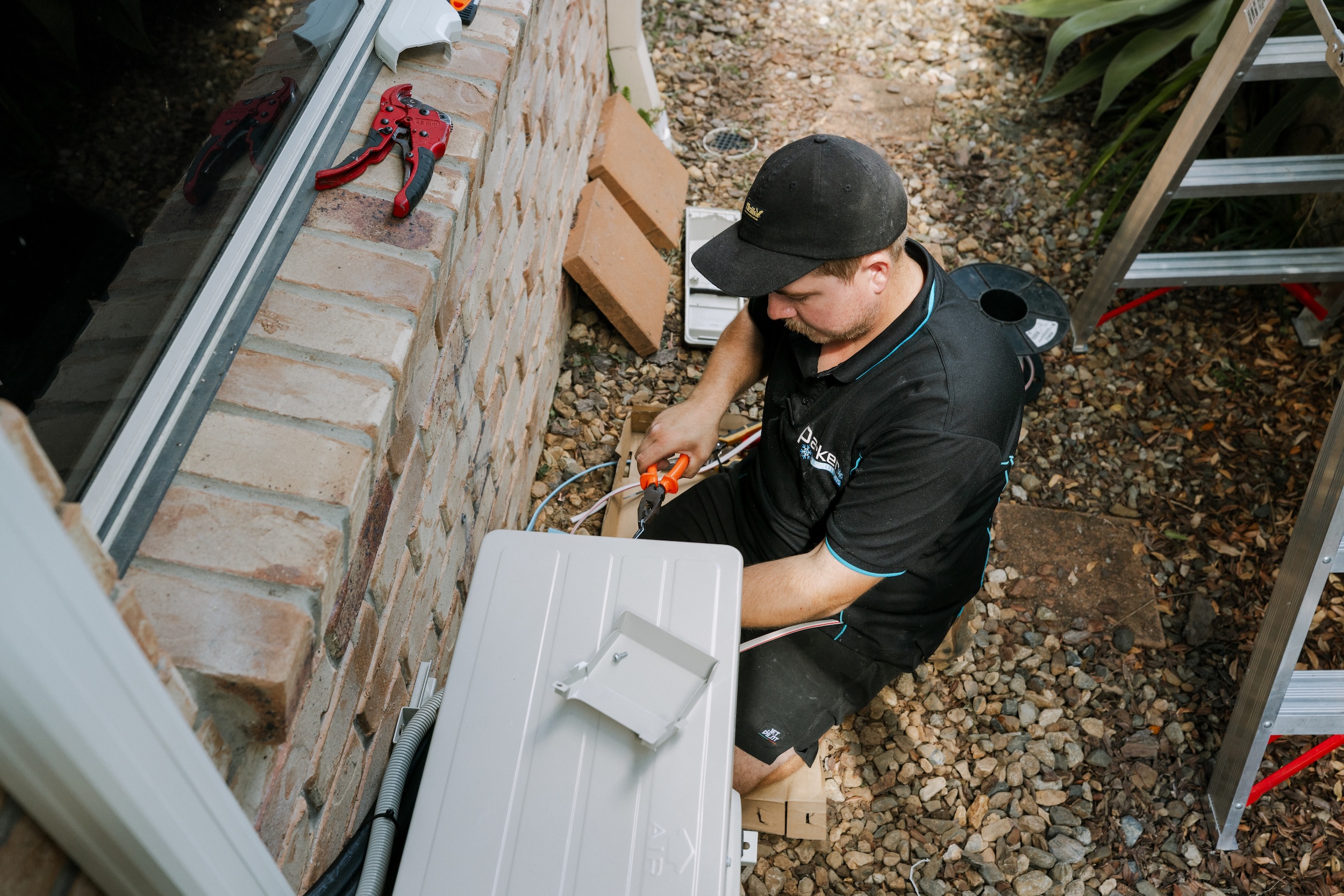 Technician connecting outdoor unit wiring