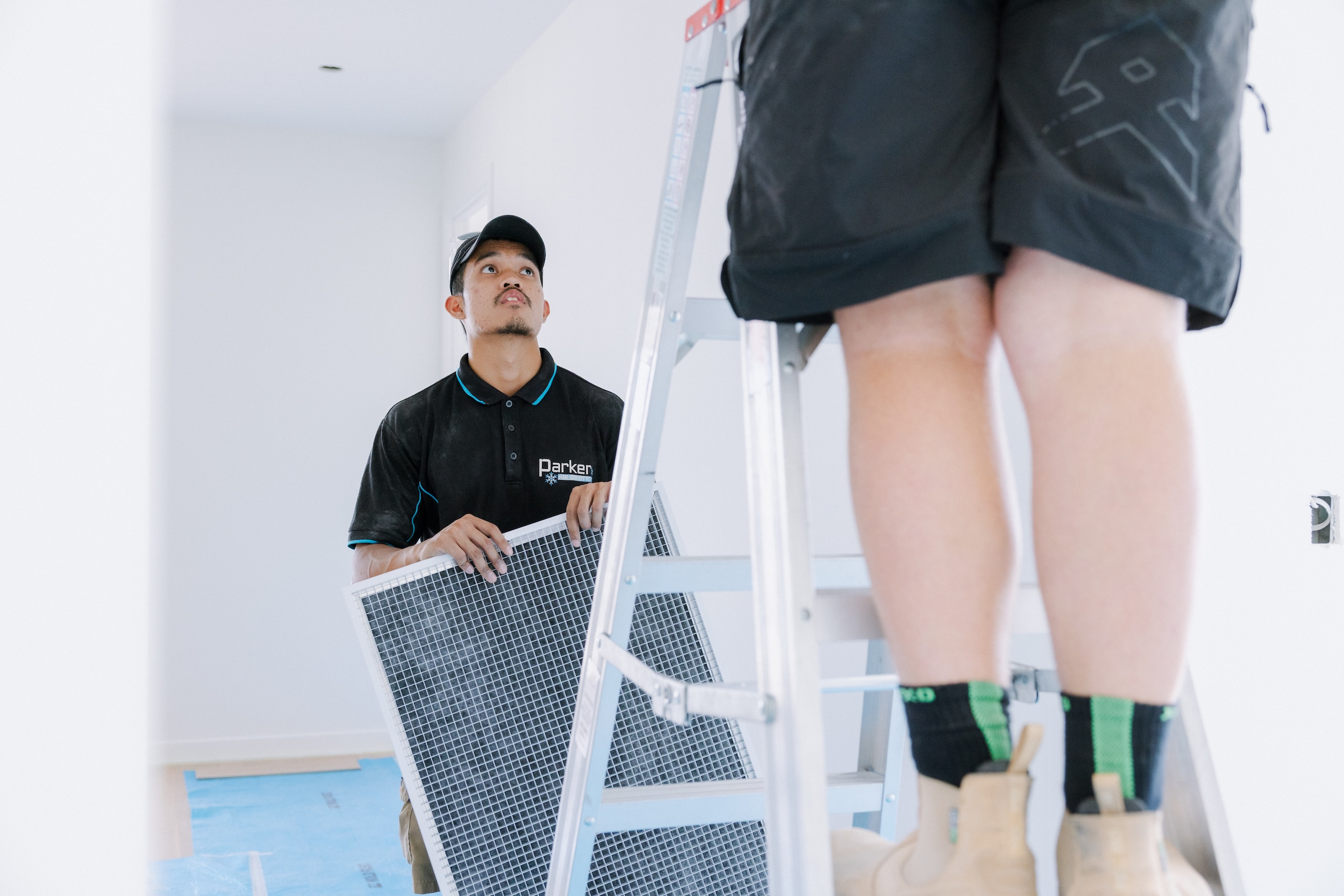 Technician fitting return air filter
